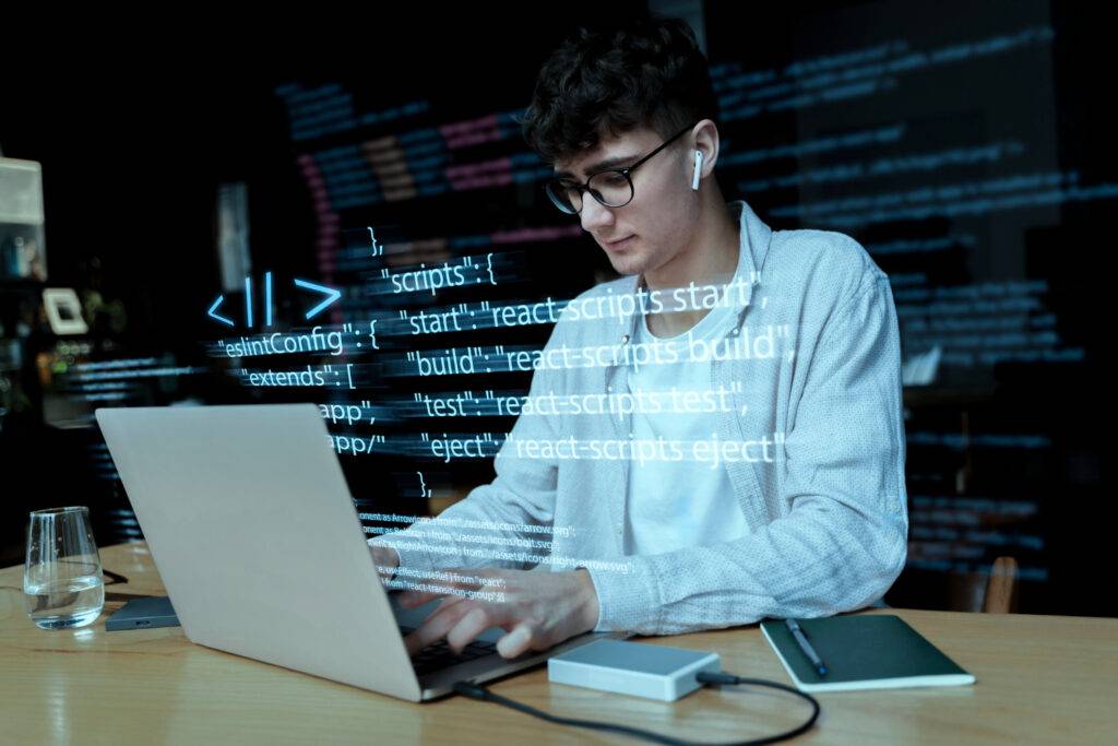 A person working with codes on a computer against a programming background.